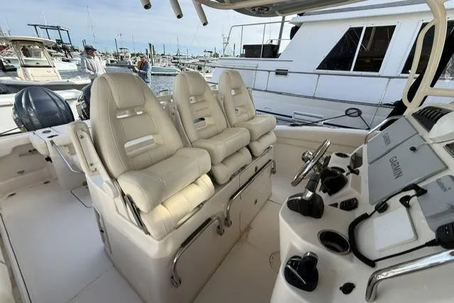 Slide: The Image of 2023 Grady-White Canyon 326 boat interior with plush seating and advanced controls. - 11