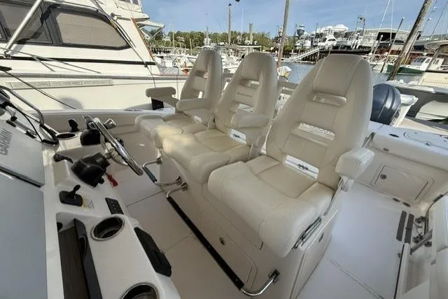 Slide: The Image of 2023 Grady-White Canyon 326 boat interior with luxurious seating and control panel. - 23