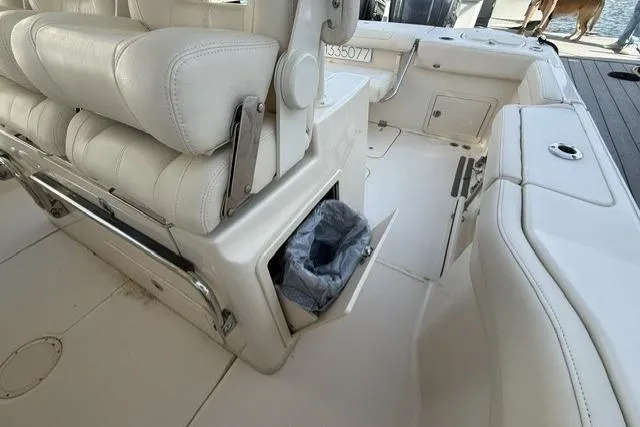 Slide: The Image of 2023 Grady-White Canyon 326 boat interior with white seating and storage compartment. - 25