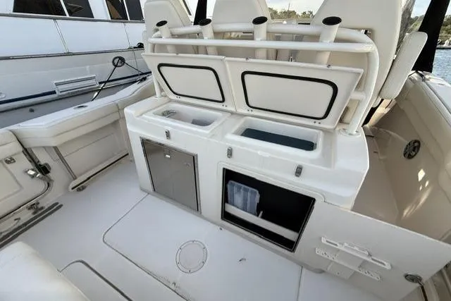 Slide: The Image of 2023 Grady-White Canyon 326 boat interior with open storage compartments and seating. - 26