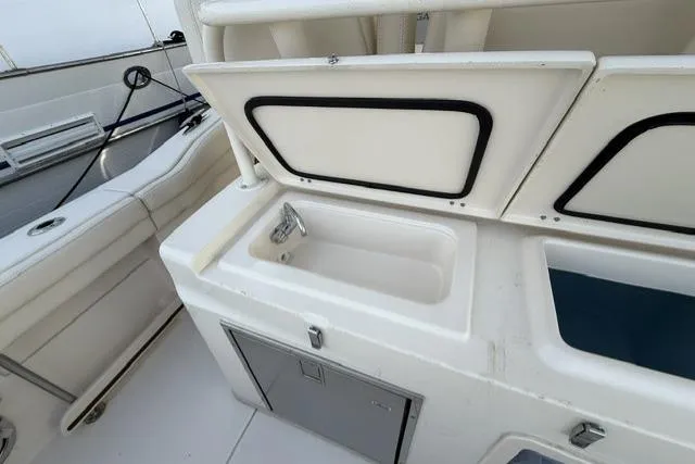 Slide: The Image of 2023 Grady-White Canyon 326 boat interior with sink and storage compartments. - 28