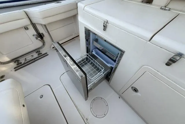 Slide: The Image of 2023 Grady-White Canyon 326 boat interior with open storage compartment. - 29