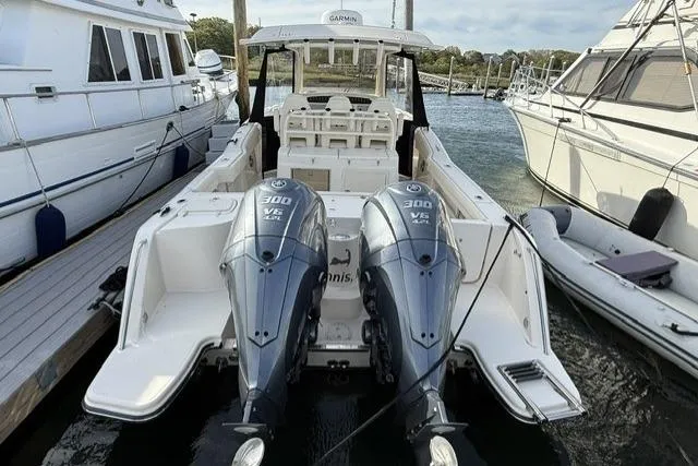 Slide: The Image of 2023 Grady-White Canyon 326 boat with twin Yamaha 300 V6 engines docked at marina. - 3