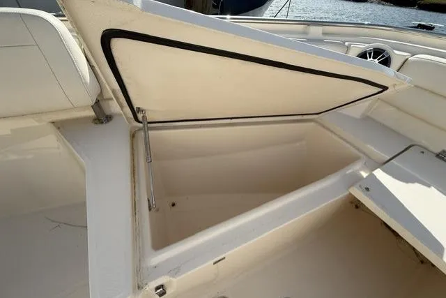 Slide: The Image of 2023 Grady-White Canyon 326 boat storage compartment open, showcasing spacious interior. - 37