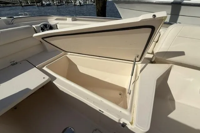 Slide: The Image of Open storage compartment on 2023 Grady-White Canyon 326 boat, dockside view. - 38