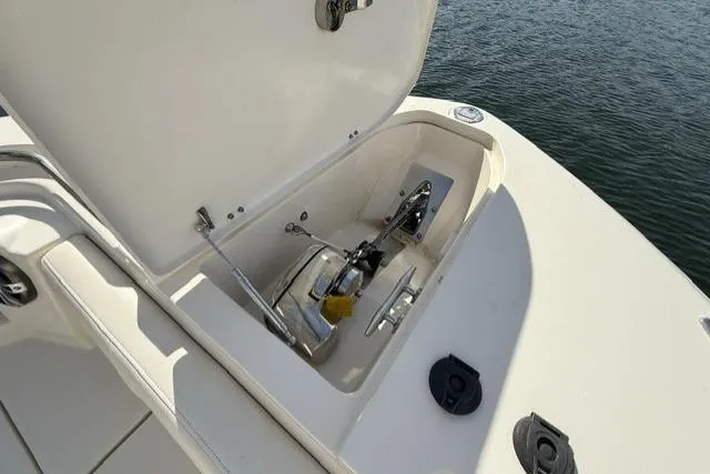 Slide: The Image of 2023 Grady-White Canyon 326 anchor compartment open, showcasing marine equipment. - 39
