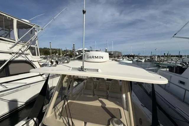 Slide: The Image of 2023 Grady-White Canyon 326 boat docked at marina with Garmin equipment. - 41
