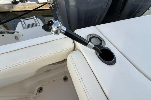 Slide: The Image of 2023 Grady-White Canyon 326 boat with fishing rod holder and cushioned seating. - 45