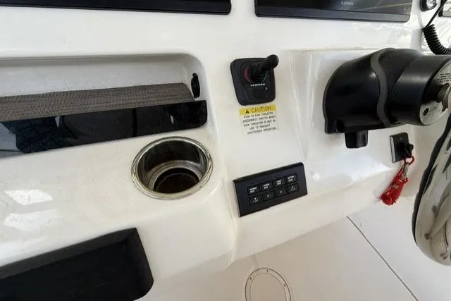 Slide: The Image of 2023 Grady-White Canyon 326 boat dashboard with controls and cup holder. - 46