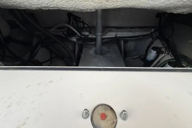 Slide: The Image of Engine compartment of 2023 Grady-White Canyon 326 boat, showing mechanical components and wiring. - 47