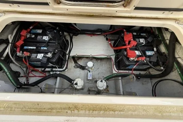 Slide: The Image of Battery compartment of 2023 Grady-White Canyon 326 boat, showing multiple batteries and wiring. - 48