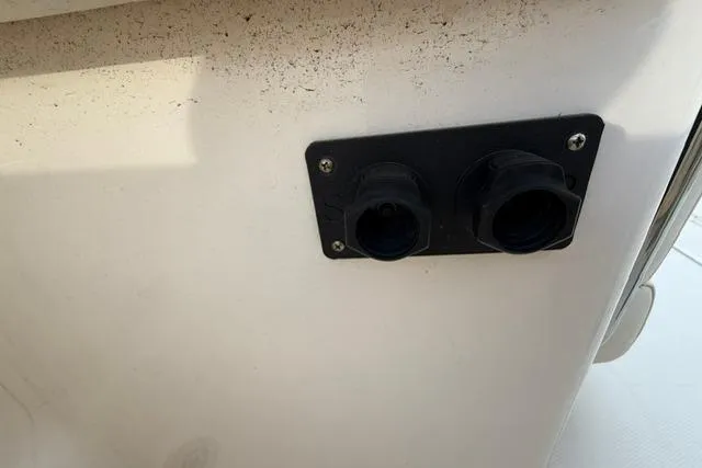 Slide: The Image of 2023 Grady-White Canyon 326 boat detail showing dual socket panel on white surface. - 49