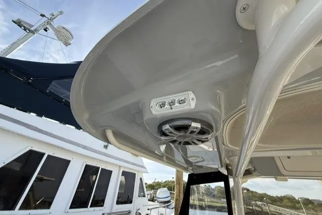 Slide: The Image of 2023 Grady-White Canyon 326 boat with speaker and light on the overhead console. - 51