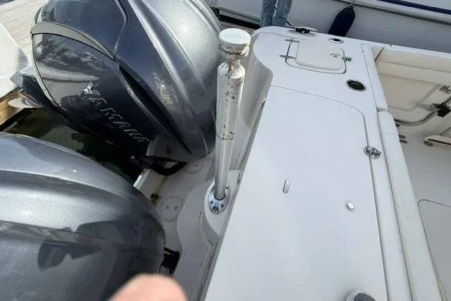 Slide: The Image of 2023 Grady-White Canyon 326 boat with dual outboard engines, docked. - 52