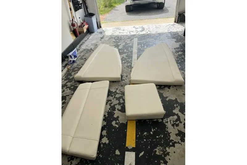 Slide: The Image of Cushions for 2023 Grady-White Canyon 326 boat, displayed on a garage floor. - 56