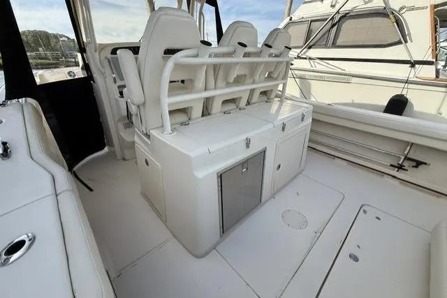 Slide: The Image of 2023 Grady-White Canyon 326 boat interior with white seating and storage compartments. - 6
