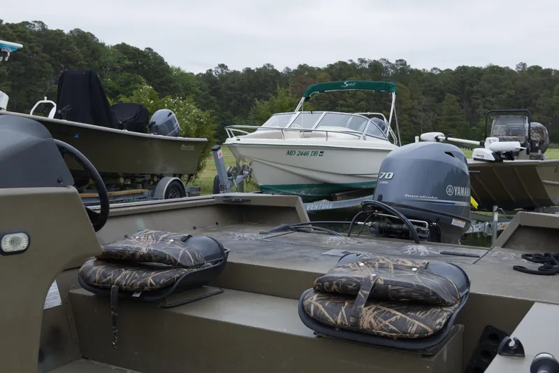 Slide: The Image of 2022 G3 Gator Tough 18 SC boat with Yamaha engine, parked among other boats. - 4