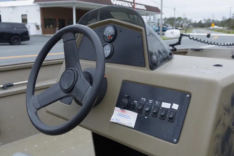 Slide: The Image of Steering console of 2022 G3 Gator Tough 18 SC boat, featuring control panel and gauges. - 7