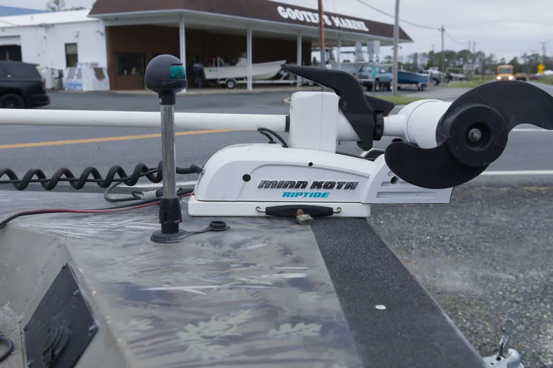 Slide: The Image of Minn Kota Riptide motor on 2022 G3 Gator Tough 18 SC boat, parked near marine store. - 9