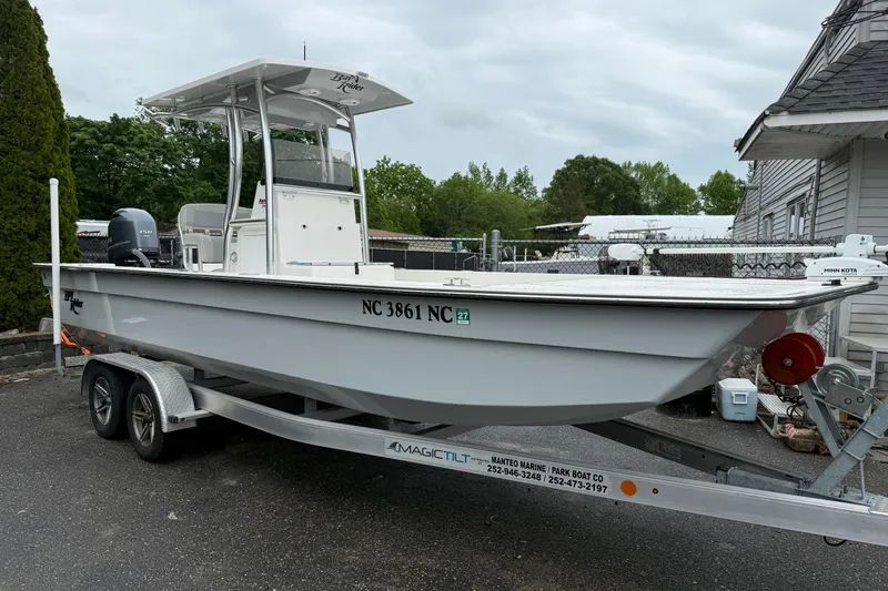The Image of 2023 KenCraft 2460 Bayrider boat on trailer, parked outdoors near a house. - 1