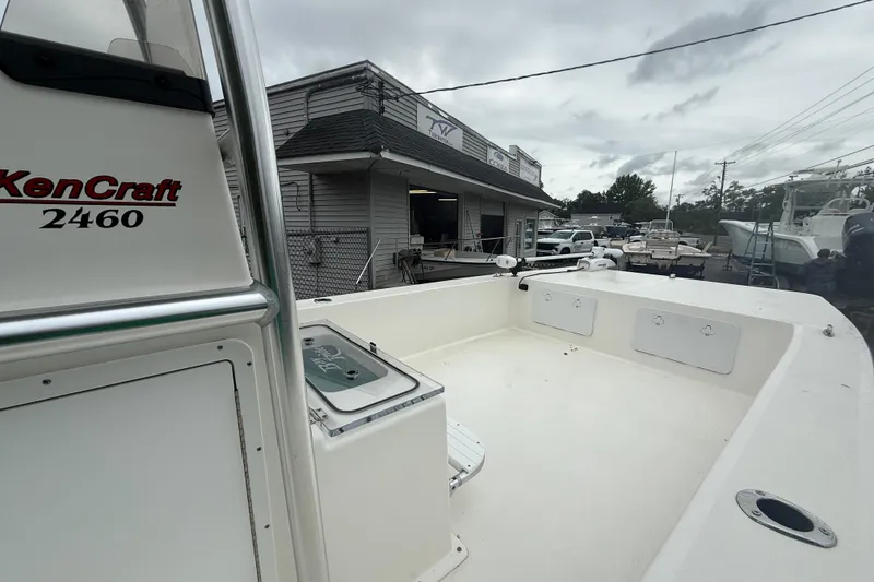 Slide: The Image of 2023 KenCraft 2460 Bayrider boat at a dealership, showcasing spacious deck and sleek design. - 4