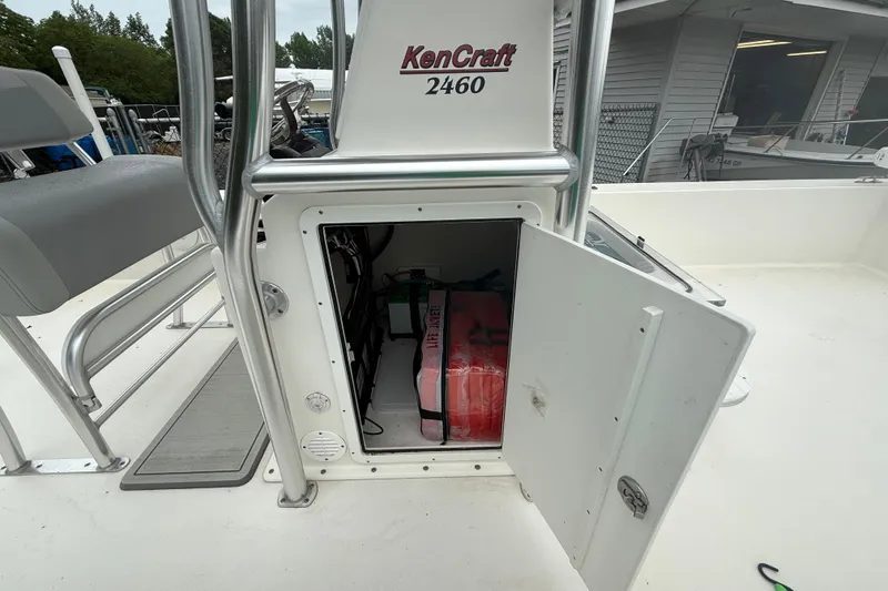 Slide: The Image of 2023 KenCraft 2460 Bayrider boat storage compartment with open door, revealing interior equipment. - 5