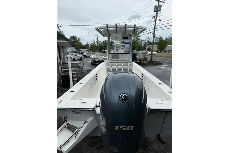 Slide: The Image of 2023 KenCraft 2460 Bayrider boat with Yamaha 150 engine, parked outdoors. - 8