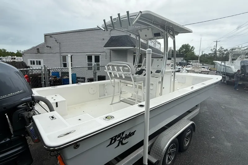 Slide: The Image of 2023 KenCraft 2460 Bayrider boat on trailer, featuring center console and spacious deck. - 9