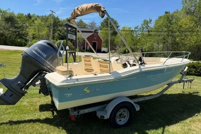 The Image of 2015 Scout 175 Sport Dorado boat with Yamaha engine on trailer, parked on grass. - 0