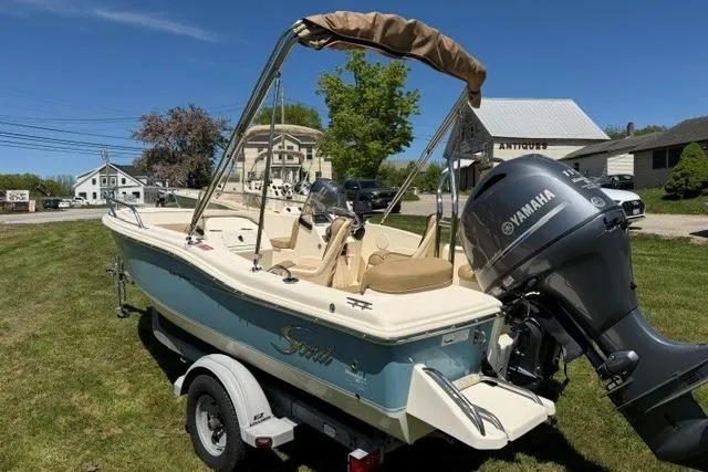 Slide: The Image of 2015 Scout 175 Sport Dorado boat with Yamaha engine on trailer, parked on grass. - 3