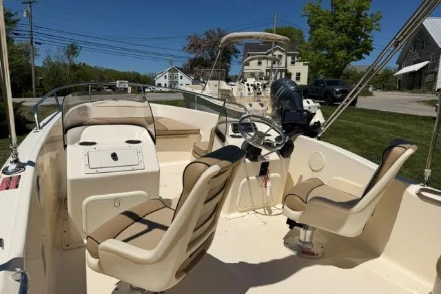 Slide: The Image of 2015 Scout 175 Sport Dorado boat interior with beige seating and steering console. - 5