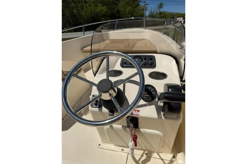 Slide: The Image of 2015 Scout 175 Sport Dorado boat steering console with gauges and controls. - 6