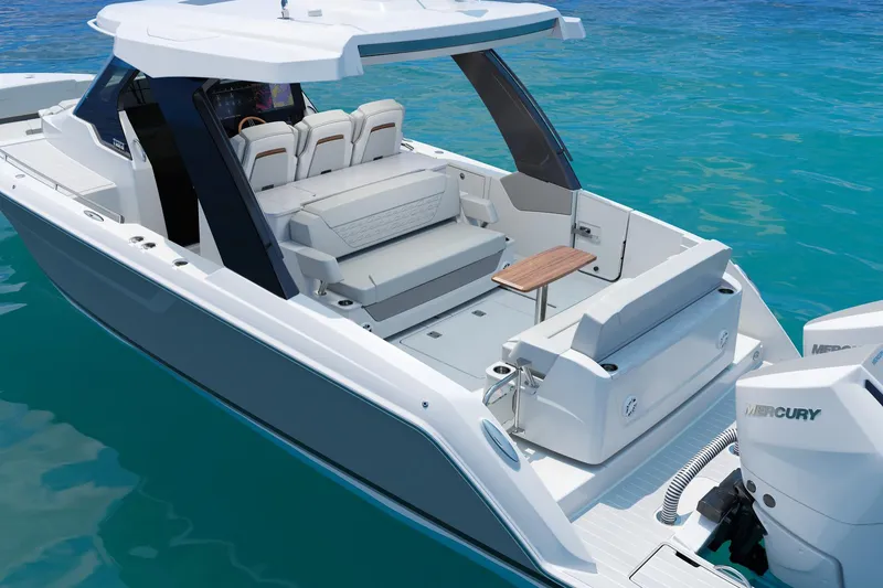 Slide: The Image of Manufacturer Provided Image: 2026 Tiara Yachts 35 LS luxury boat with spacious seating and modern design on clear blue water. - 2