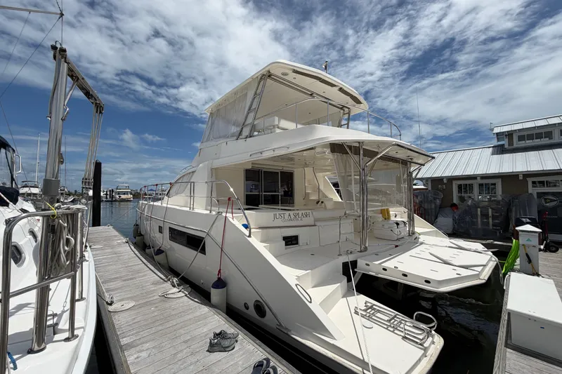 Slide: The Image of 2015 Leopard 51 Powercat docked at marina under a partly cloudy sky. - 1
