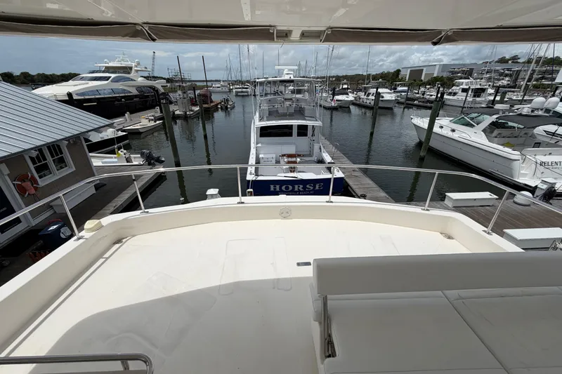 Slide: The Image of 2015 Leopard 51 Powercat docked at marina, view from upper deck, surrounded by boats. - 10