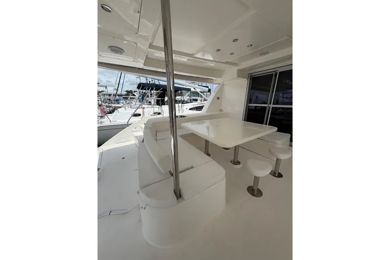 Slide: The Image of Spacious deck area on a 2015 Leopard 51 Powercat yacht, featuring seating and table. - 11
