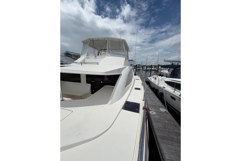 Slide: The Image of 2015 Leopard 51 Powercat yacht docked under a partly cloudy sky. - 19