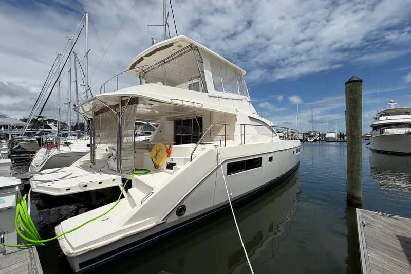 The Image of 2015 Leopard 51 Powercat yacht docked at marina under blue sky. - 2