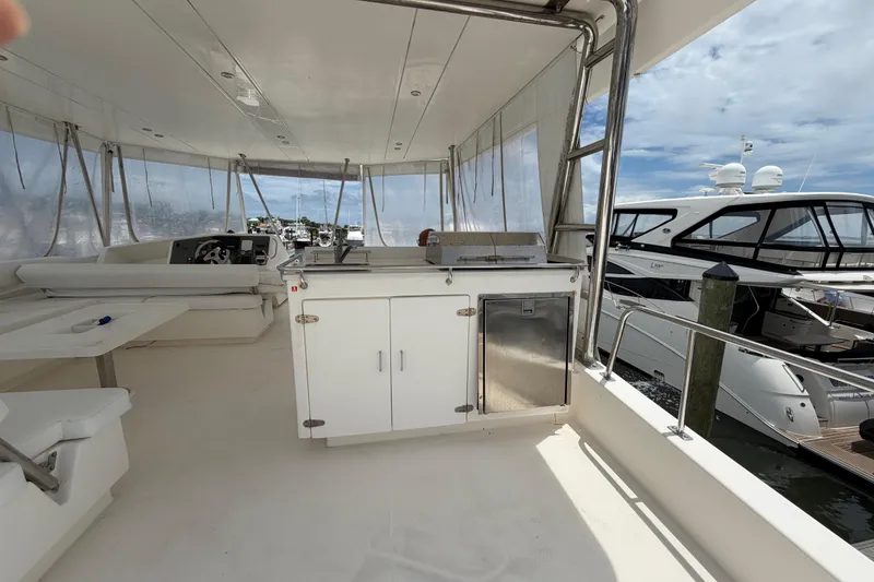 Slide: The Image of Spacious deck of 2015 Leopard 51 Powercat with seating and kitchenette, docked at marina. - 22