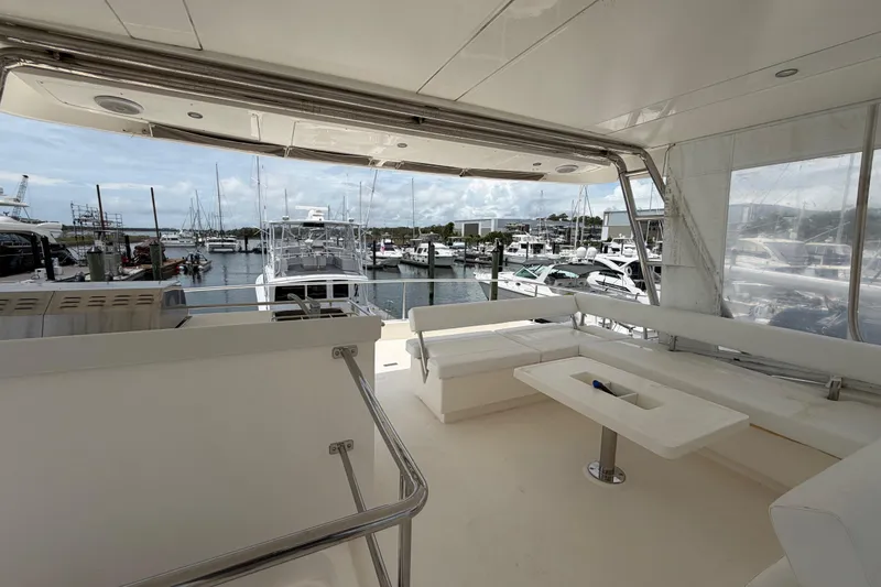 Slide: The Image of Spacious deck of 2015 Leopard 51 Powercat overlooking marina with boats and clear skies. - 26
