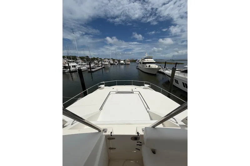 Slide: The Image of 2015 Leopard 51 Powercat yacht docked in a marina under a partly cloudy sky. - 27