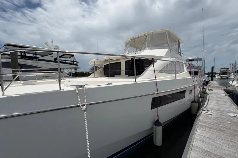 Slide: The Image of 2015 Leopard 51 Powercat yacht docked at marina under cloudy sky. - 3