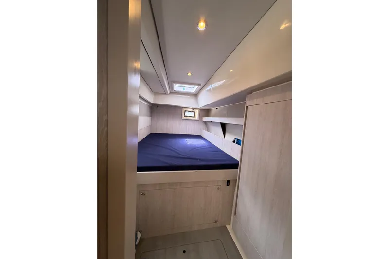 Slide: The Image of Cabin interior of 2015 Leopard 51 Powercat with bed and storage, featuring modern design. - 32