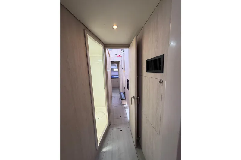 Slide: The Image of Interior hallway of 2015 Leopard 51 Powercat yacht, featuring modern design and lighting. - 33