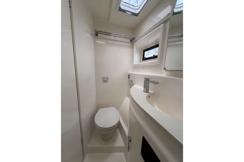 Slide: The Image of Bathroom interior of 2015 Leopard 51 Powercat yacht, featuring modern fixtures and skylight. - 40