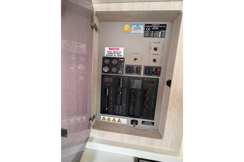 Slide: The Image of Electrical panel inside 2015 Leopard 51 Powercat, featuring switches and gauges. - 46