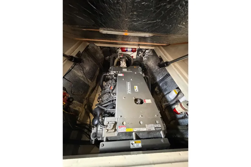 Slide: The Image of Engine compartment of a 2015 Leopard 51 Powercat, featuring a Yanmar engine. - 57
