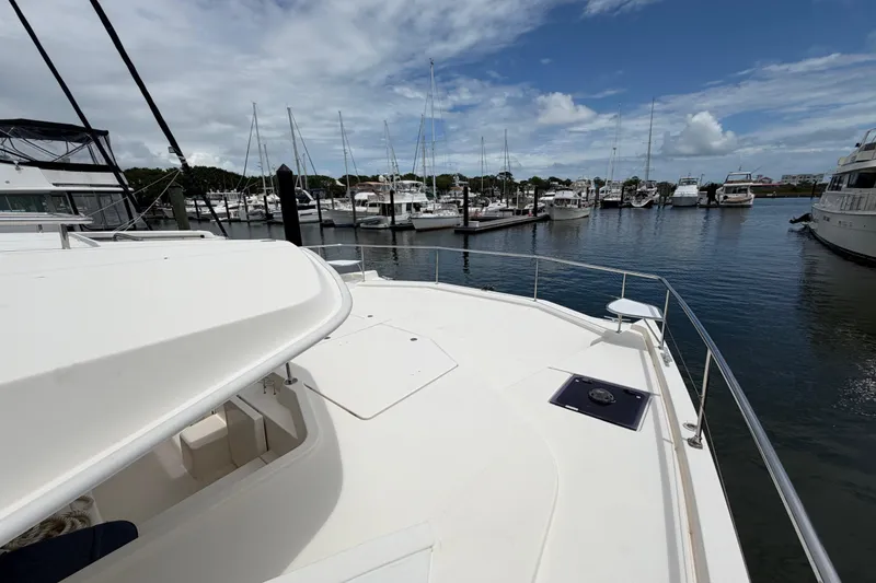 Slide: The Image of Leopard 51 Powercat 2015 at marina, surrounded by boats under a partly cloudy sky. - 7