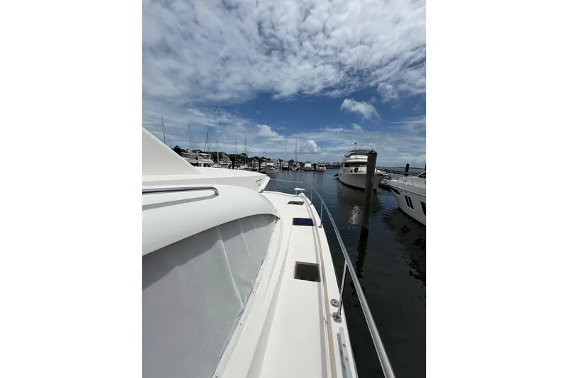 Slide: The Image of 2015 Leopard 51 Powercat docked in a marina under a partly cloudy sky. - 8