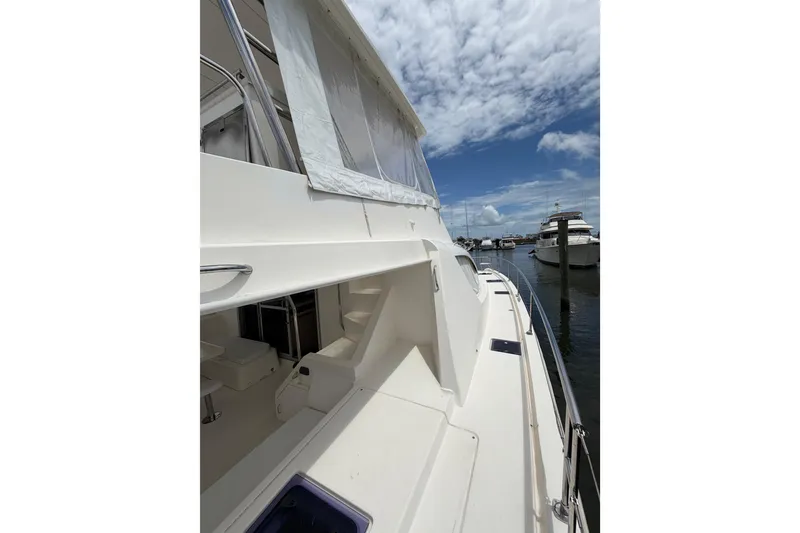 Slide: The Image of 2015 Leopard 51 Powercat yacht docked under a partly cloudy sky. - 9